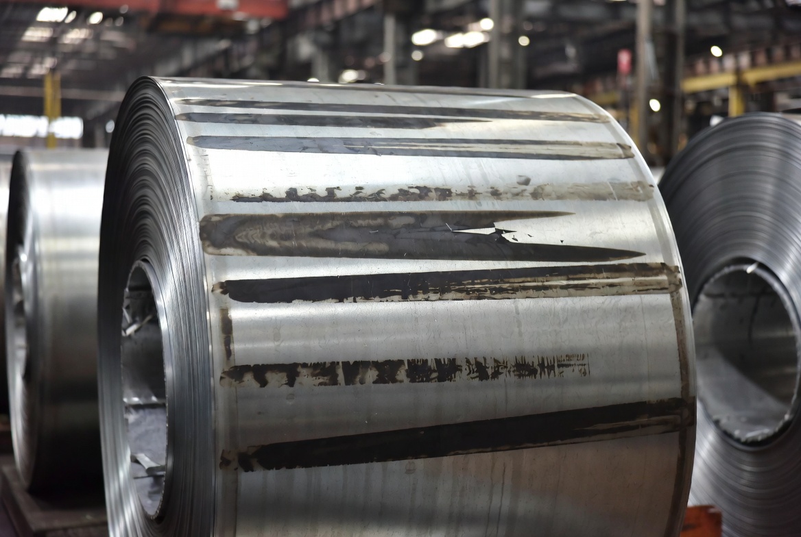 Rolled steel coil showing longitudinal dark streaks known as tiger stripes